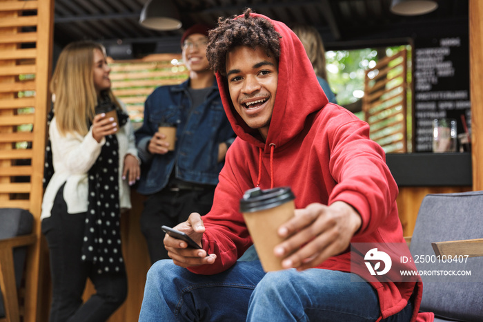 Smiling african teenager sitting outdoors