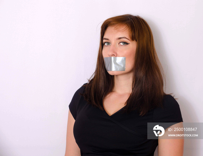 Young woman with taped mouth