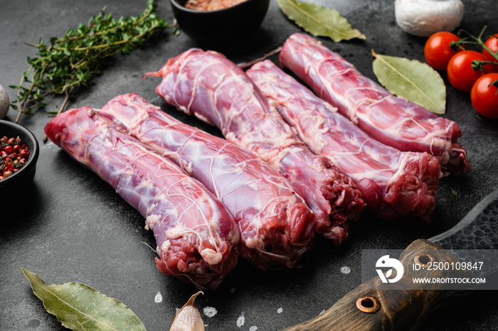 Fresh raw duck neck without skin, on black dark stone table background