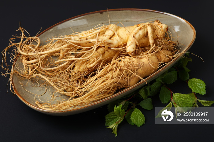 ginseng root on black background