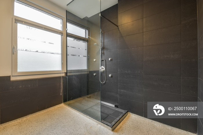 Modern shower cabin with glass door in the bathroom at home