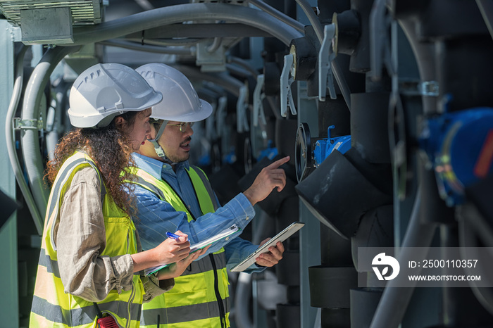 worker checking job in plant room. worker co-worker on Air condition system planton background. engineer female and male checking on Air condition plant. Two worker working on Air condition (HVAC).