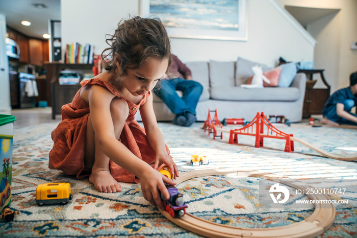 Girl playing with toy train in living room