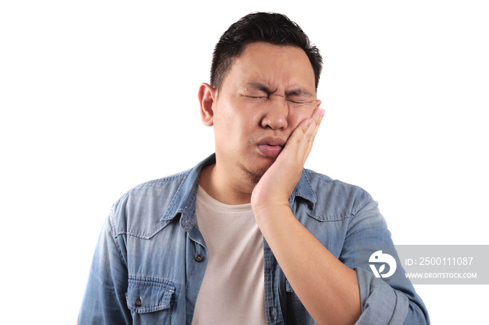 Portrait of Asian man suffering toothache pain, against white