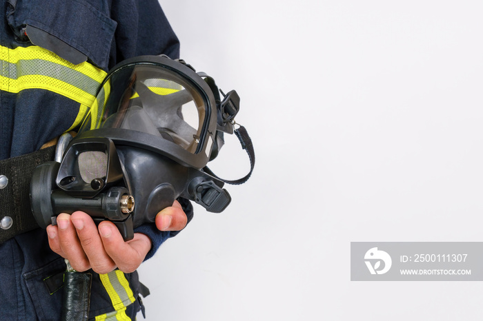 Full protective breathing air mask in hand of unrecognized african-american firefighter, rescue and fire fighter equipment isolated on white background, copy space