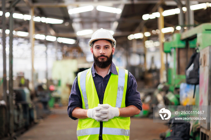 Portrait Professional mechanical engineering hispanic male in white safety hard hat helmet and look at camera at metal factory.