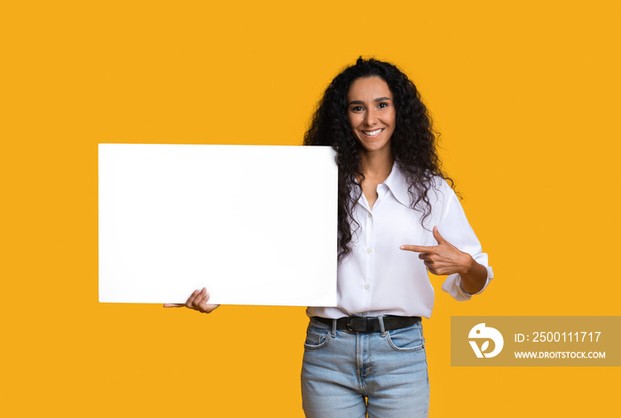 Free Place For Ad. Smiling Brunette Woman Pointing At White Blank Placard