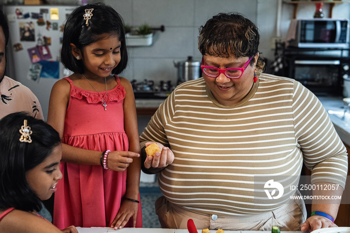 Kids helping their parent cook a healthy meal for the family dinner at home