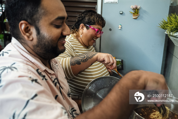 Plus sized parents making a healthy meal for the family