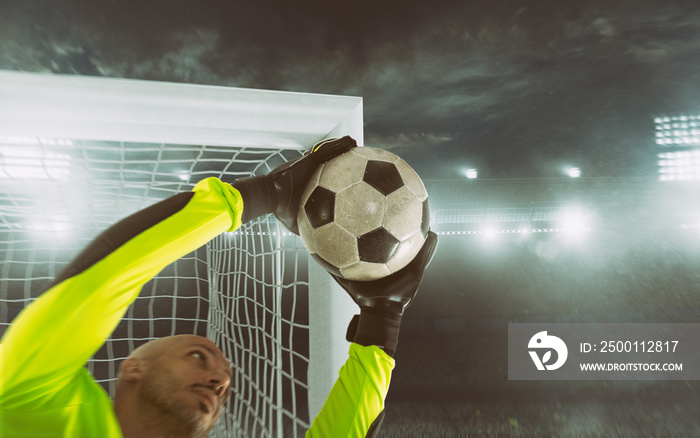 Close up of a soccer goalkeeper saving the ball at the corner of the goalposts