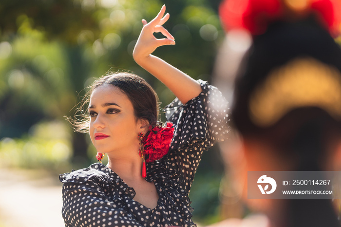 Selective focus on a beauty hispanic woman dancing flamenco in a park