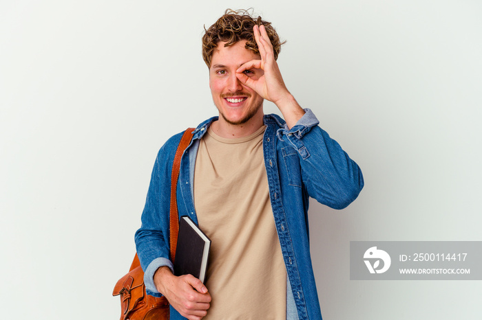 Young student man isolated on white background excited keeping ok gesture on eye.