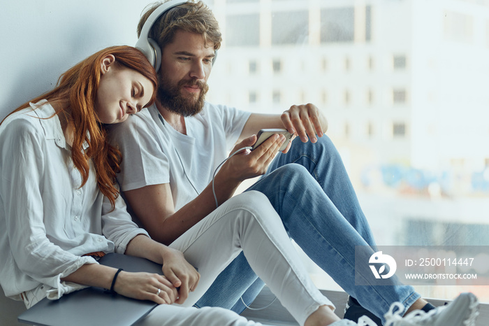 a young couple chatting near the window romance joy technology