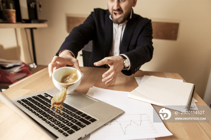 Coffee in white cup spilling on the table in the morning working day at office table