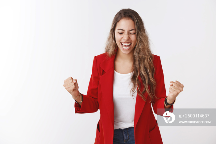 Girl yelling happiness, clenching fists victory celebrating success smiling broadly close eyes achieve goal, winning, victory good news lucky opportunity, standing delighted white background