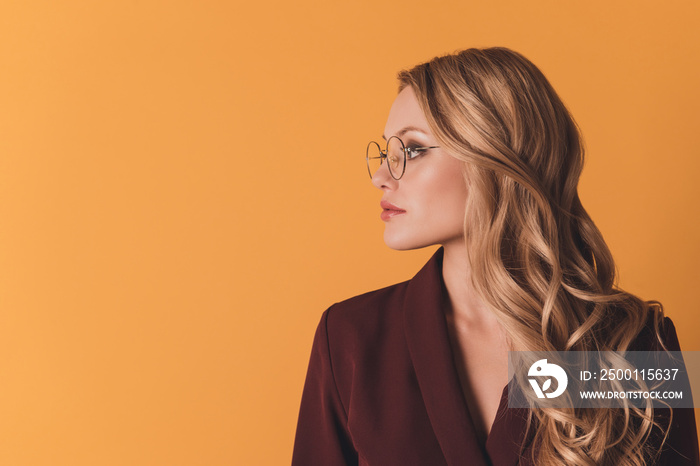 Profile portrait with copyspace, empty place of lovely, pretty clever, thoughtful, concentrated woman isolated on dark yellow background, advertisement concept