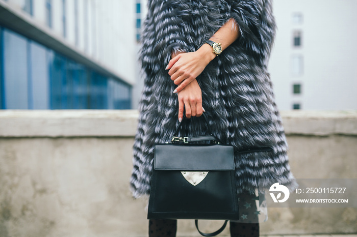 stylish woman in winter fur coat walking in street