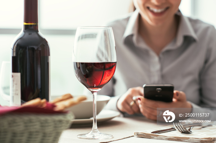 Woman using a smartphone at the restaurant