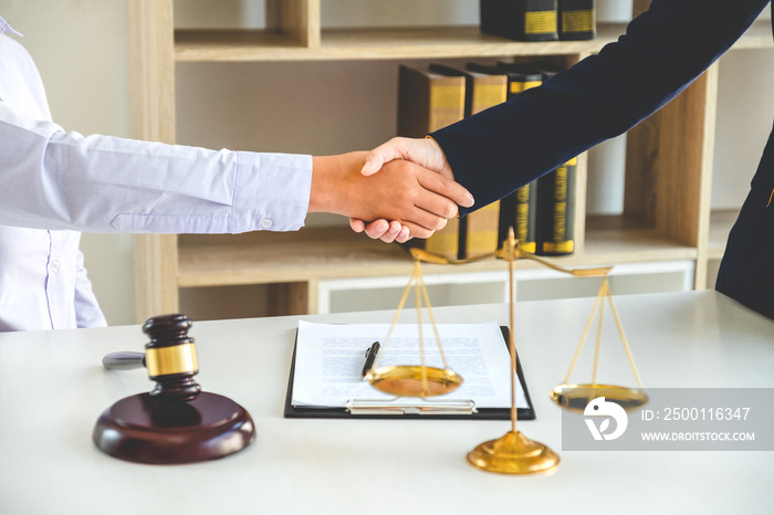 Businessman shaking hands to seal a deal Judges male lawyers Consultation legal services Consulting in regard to the various contracts to plan the case in court.