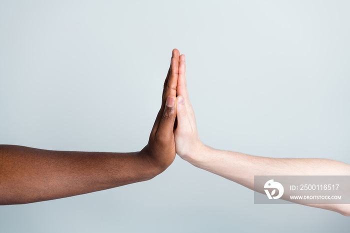 Closeup photo of two arms clap giving five different race multinational relationship antiracism issue help together world globe partners immigration integration isolated grey color background