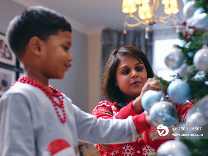 Mother and son decorating Christmas tree