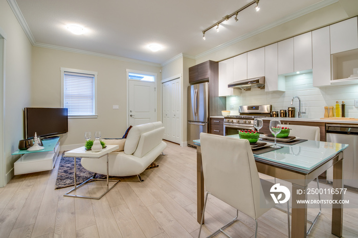 Bright living room with kitchen and dinner table. Interior design.