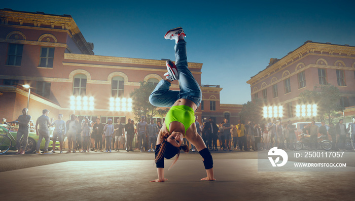 Street dancer girl  dance breakdance on evening street