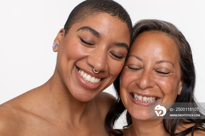 Studio portrait of smiling women with eyes closed