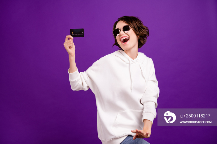 Photo portrait girl in sunglass showing bank card isolated bright pastel color background