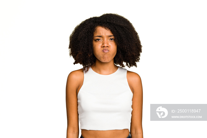 Young African American woman isolated blows cheeks, has tired expression. Facial expression concept.