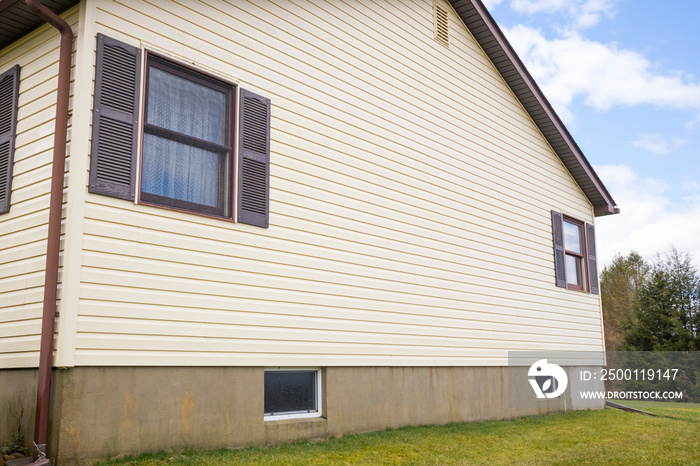 House with pale yellow vinyl siding