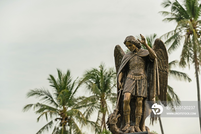 Archangel Michael Sculpture, The archangel isolated on isolated against a blue sky at sunlight.