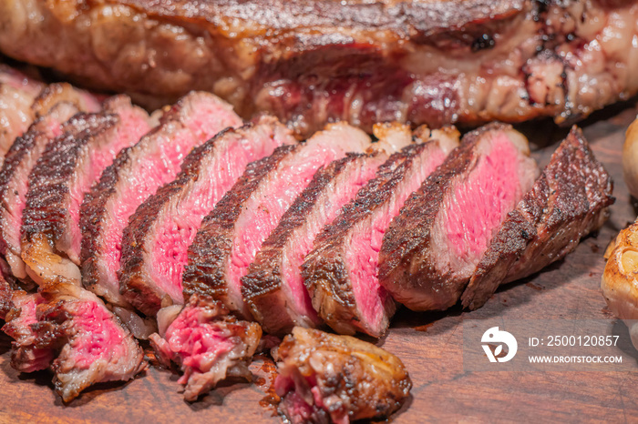 Dry-aged marble beef steak Tomahawk on wooden board with spices. Close-up, dinner concept.