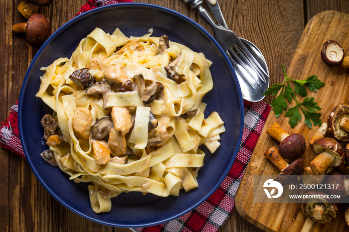 Tagliatelle pasta with forest mushrooms and chicken.