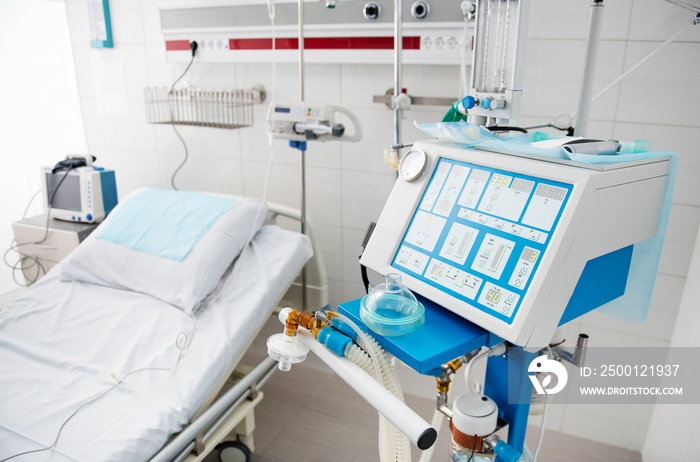 Comfort for patients. Hospital room in white tones with bed, breathing apparatus and digital device for measuring blood pressure