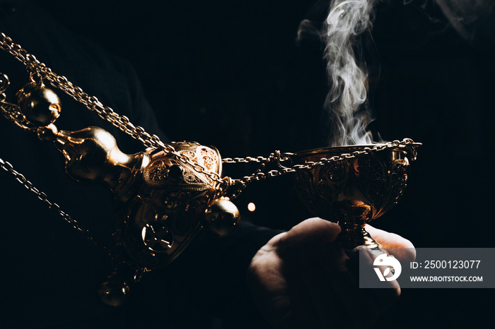 censer in the hands of the priest, incense and smoke