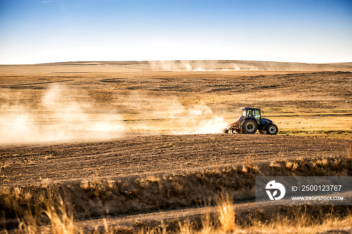 A farmer in tractor on arid land.Traditional farming practices in Turkey