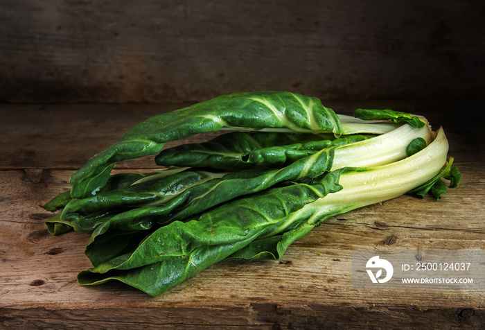 Chard or mangold, raw organic leaf vegetable on a rustic wooden table