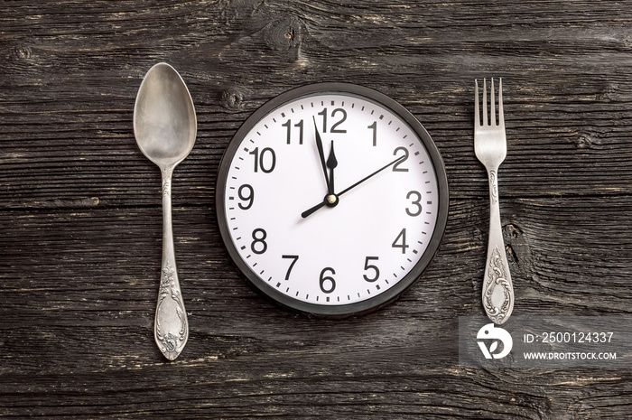 Clock with fork and spoon.Top view. Time to eat.