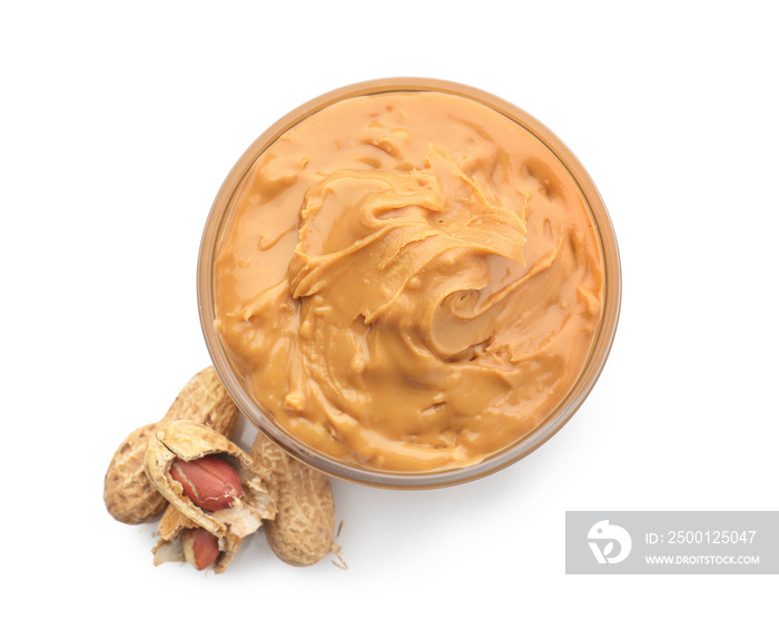 Bowl with tasty peanut butter on white background