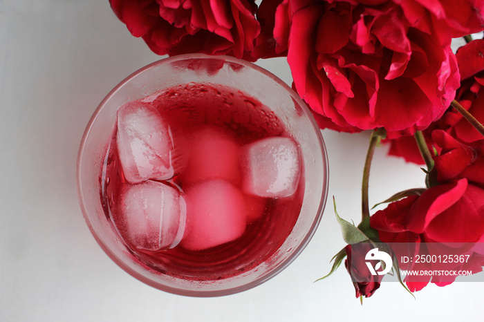 Cold hibiscus tea with ice cubes in the glass. Refreshing non-alcoholic summer drink