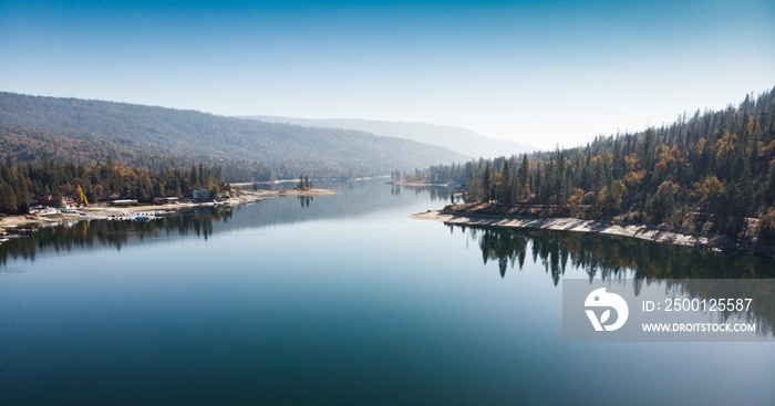 Forest reflected in the water of Bass river in California