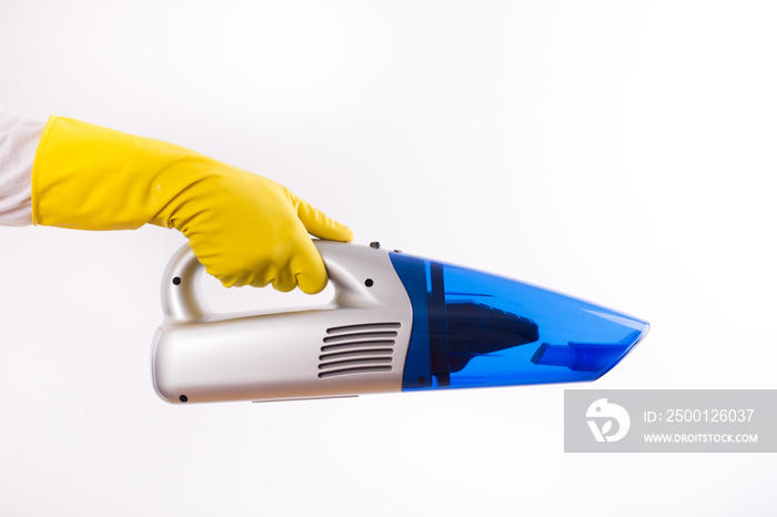 Maid holding vacuum cleaner on white