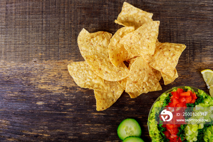 Tortilla chips, avocado dip, tomato and cucumber