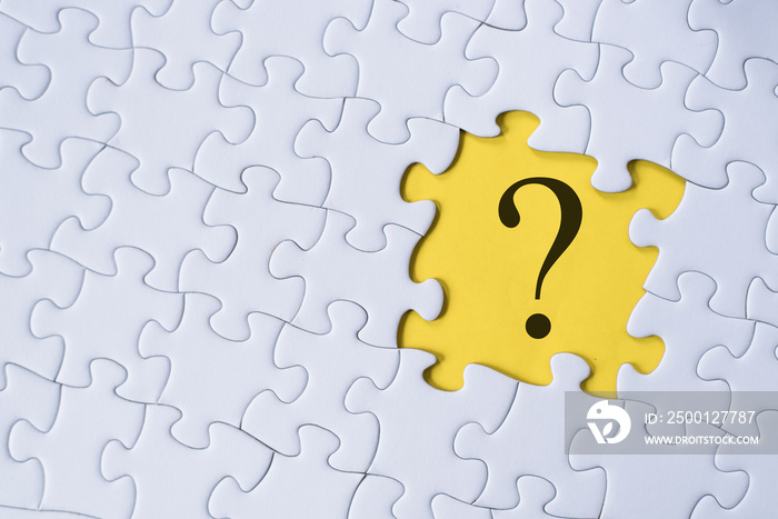 question mark on jigsaw puzzle with yellow background. question, faq and q&a concept