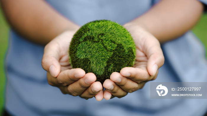 Close up of hands holding the earth on a green background. protect nature. Save Earth. concept of the environment World Earth Day