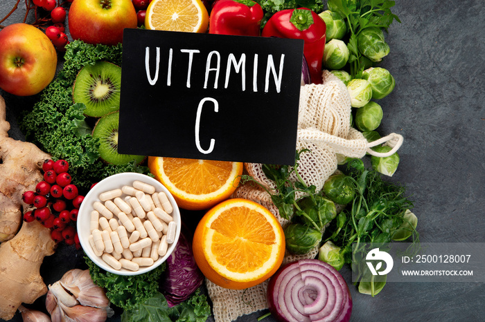 Foods high in vitamin C on dark background.