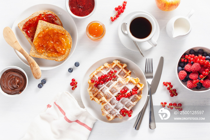 breakfast with waffle, toast, berry, jam, chocolate spread and coffee. Top view