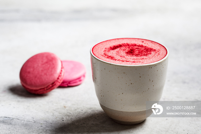 Pink beetroot latte in a ceramic glass.