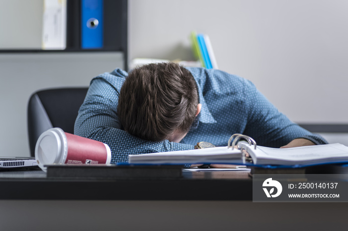 tired worker sleeping at a desk